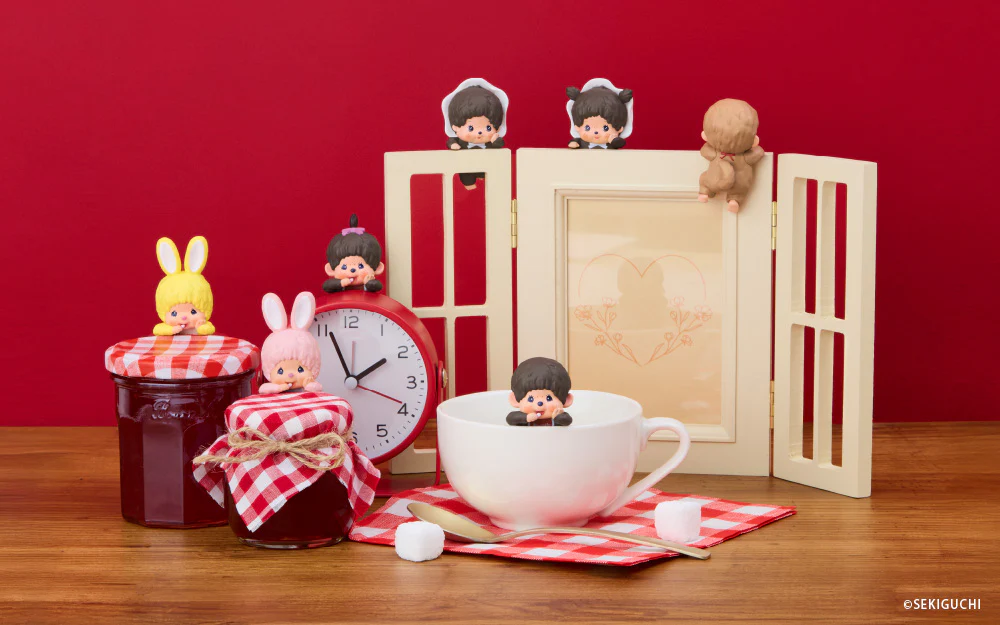 Miniature figures and items on a wooden surface with a red background