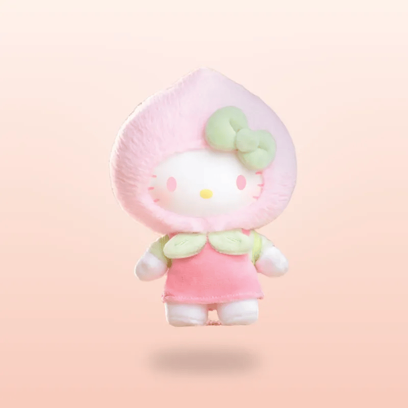 A Hello Kitty plush toy styled as a peach character, wearing a pink hood with a light green bow and matching green leaf accents, set against a soft peach-pink gradient background.